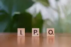 Wooden letter blocks spelling IPO on a table, symbolizing investment opportunities.